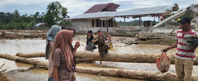 warga gampong jambak, Pante Cermin mencai sisa barang rumah yang tersisa di bawah runtuhan bangunan. Jumat 28/11/2025.
