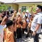 Bupati Aceh Besar, H Muharram Idris tampak penuh keakrab dengan murid saat berkunjung di SDN Limpok, Darussalam, Aceh Besar, Jumat (08/05/2026). 